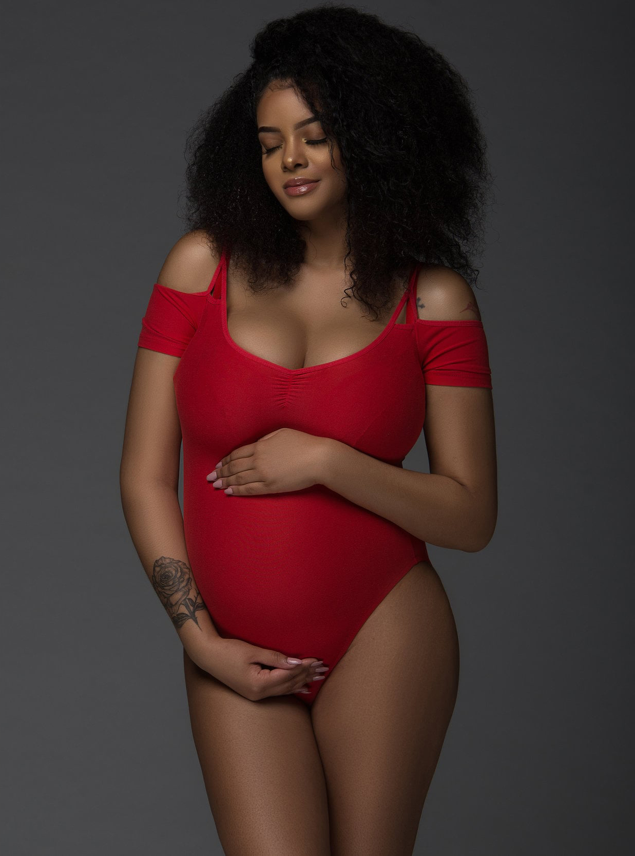Bold red bodysuit maternity fashion portrait by Chicago maternity photographer Sri & Jana