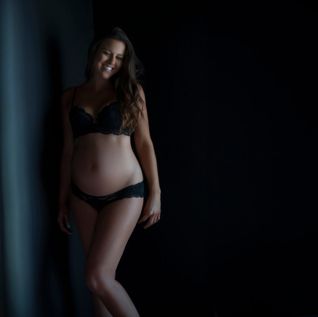 Pregnant lady in black lingerie boudoir style maternity photos in Chicago Studio