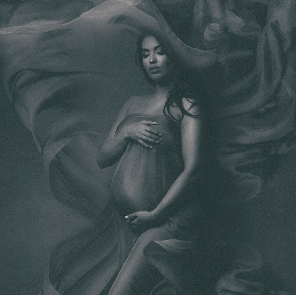 Dramatic italian silk flying in all directions pregnant lady in chicago at photography studio